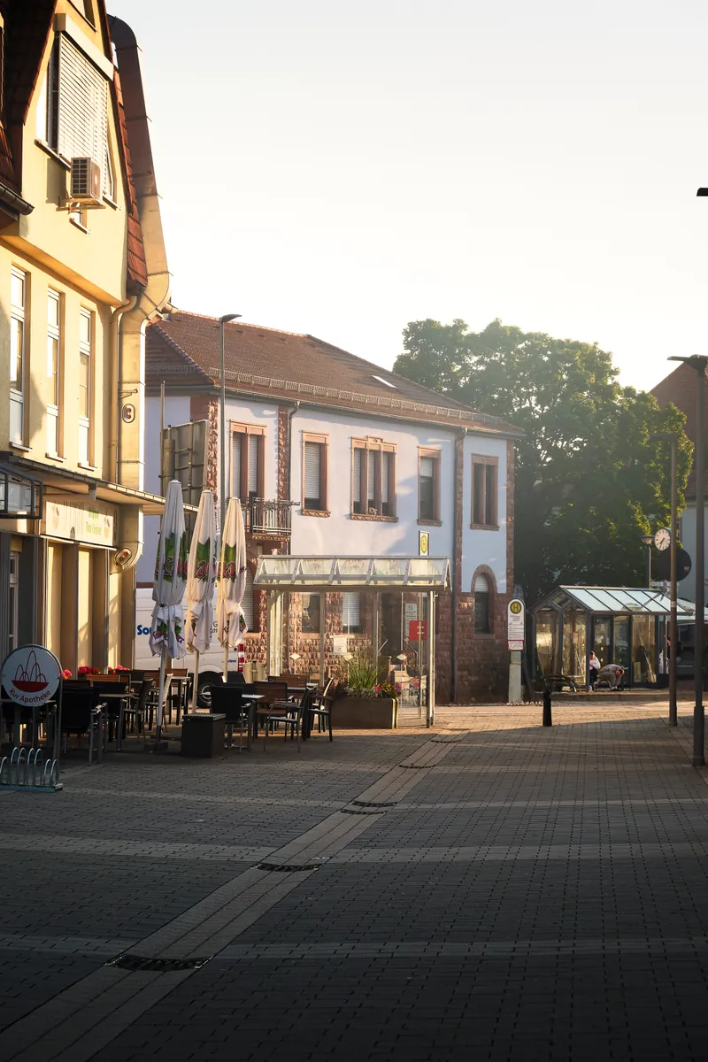 Landstuhl's market square, café awnings lit by late-afternoon sun